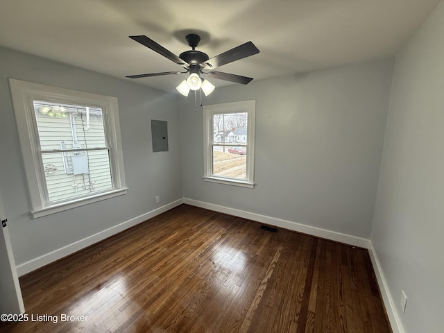 unfurnished room with dark wood-type flooring, electric panel, and ceiling fan