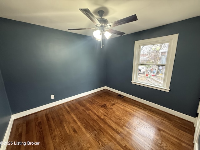 empty room featuring wood-type flooring and ceiling fan