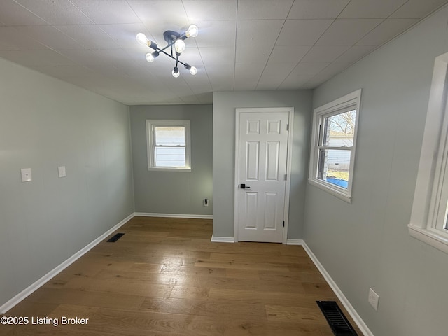 unfurnished room with a healthy amount of sunlight and light hardwood / wood-style floors