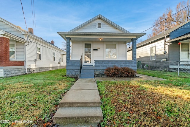 bungalow-style house with a porch and a front lawn