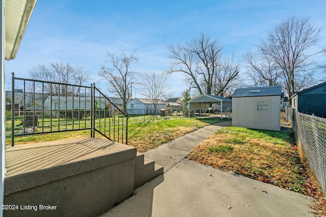 view of yard featuring a storage unit and a carport