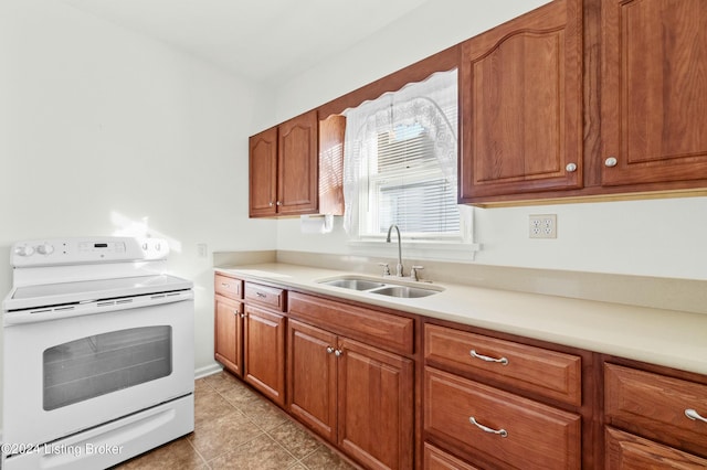 kitchen with white range with electric stovetop, light tile patterned floors, and sink