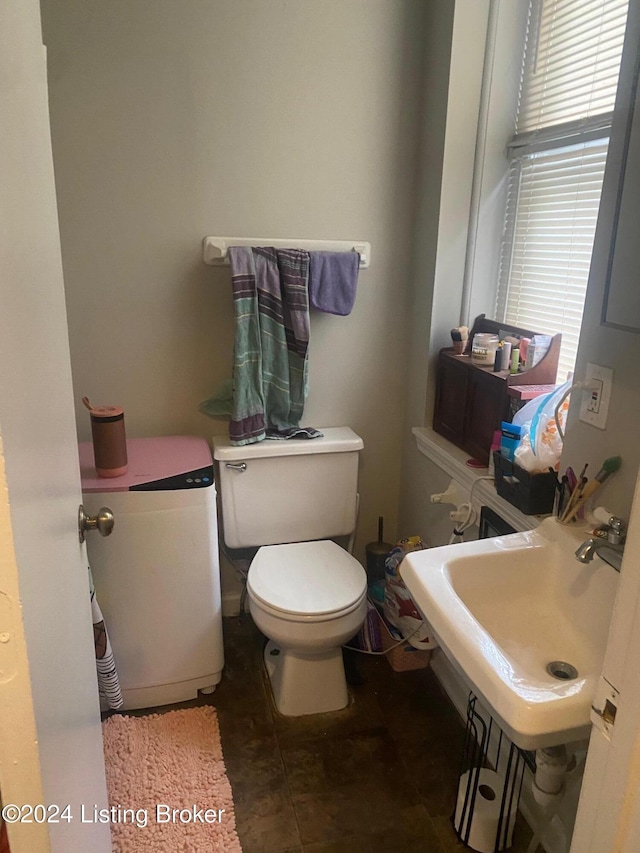 bathroom with sink, tile patterned flooring, plenty of natural light, and toilet