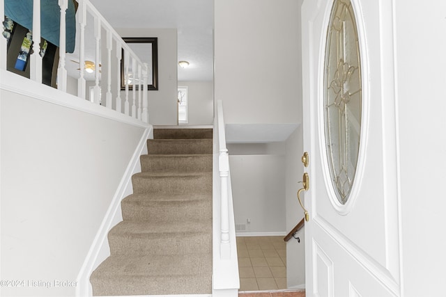 stairway featuring tile patterned floors