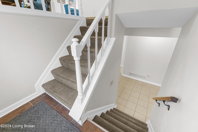 stairway featuring tile patterned floors