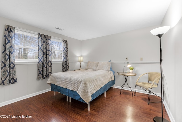 bedroom with dark hardwood / wood-style flooring