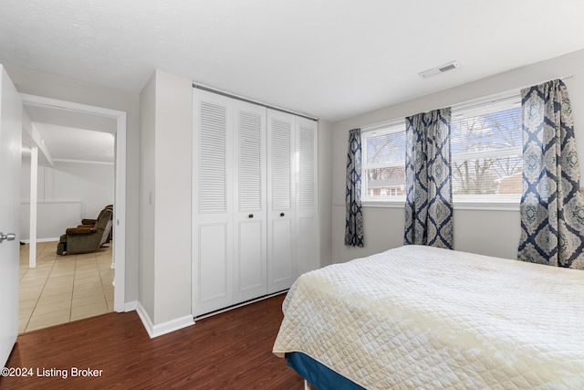 bedroom featuring dark wood-type flooring and a closet