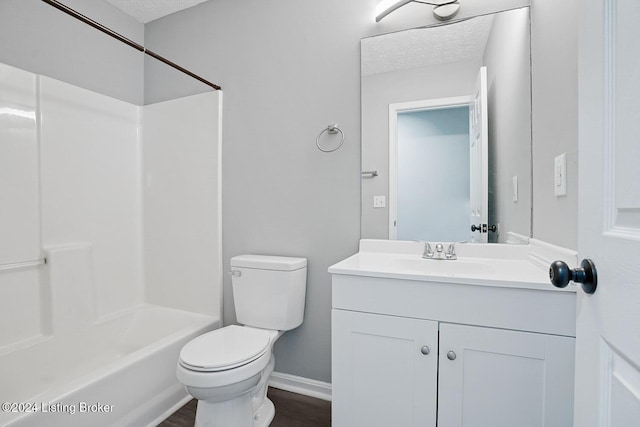 full bathroom featuring vanity, tub / shower combination, toilet, and a textured ceiling