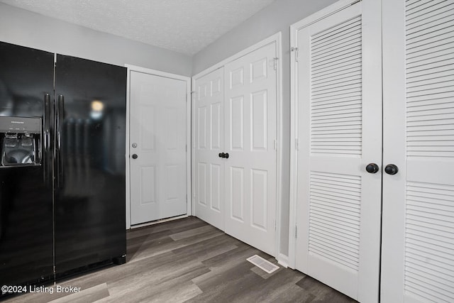 interior space with hardwood / wood-style floors and a textured ceiling