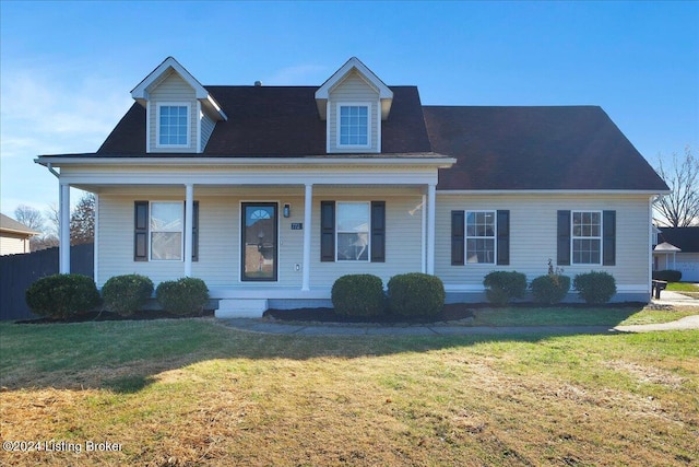 new england style home with a porch and a front yard