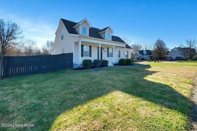 cape cod-style house with covered porch and a front yard