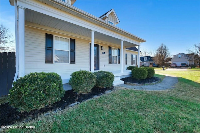 view of front of home with a porch and a front yard