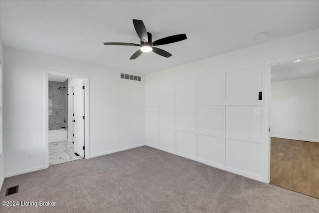 unfurnished bedroom with ensuite bathroom, ceiling fan, and light colored carpet