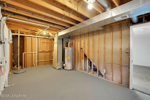 basement featuring heating unit and gas water heater