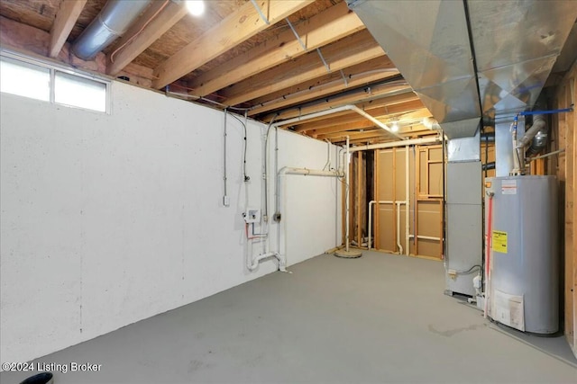 basement featuring heating unit and water heater