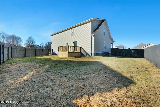 rear view of property with central AC, a yard, and a deck