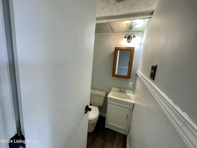 bathroom with vanity, wood-type flooring, and toilet