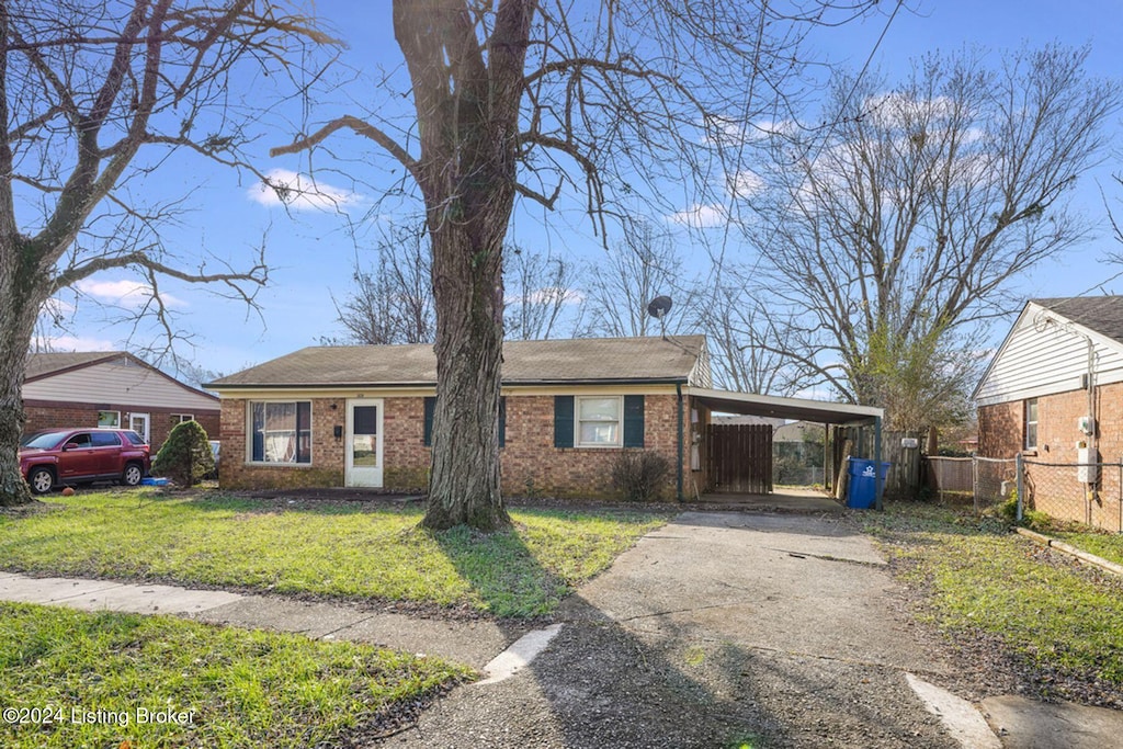 view of front of property with a carport and a front lawn