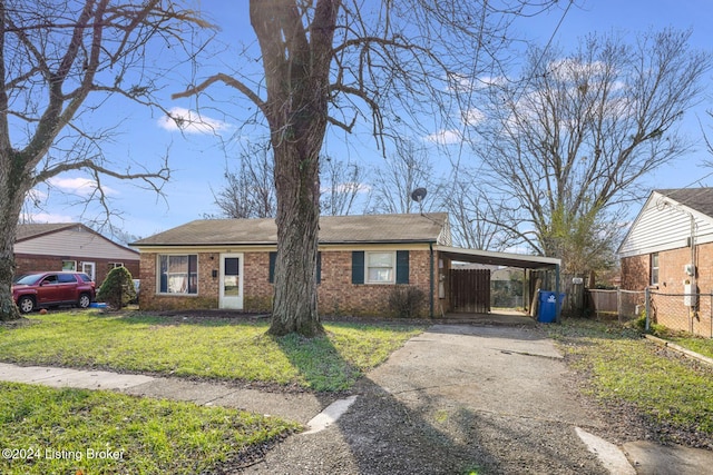 view of front of property with a carport and a front lawn