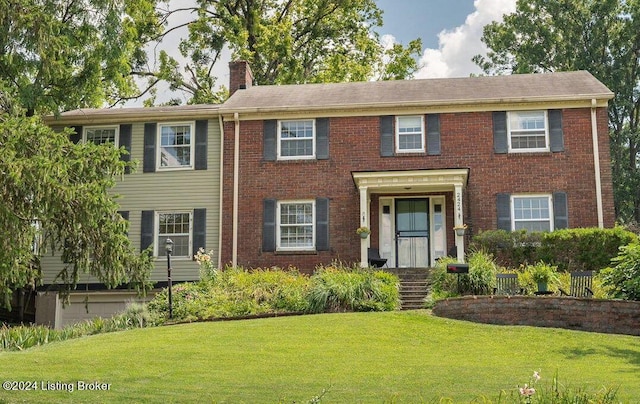 colonial home with a front lawn