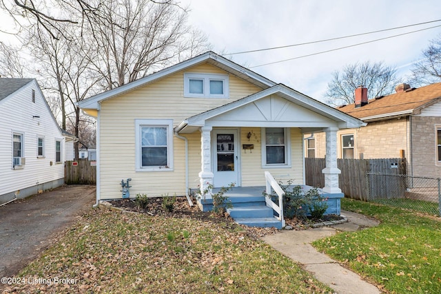 bungalow featuring a porch and cooling unit