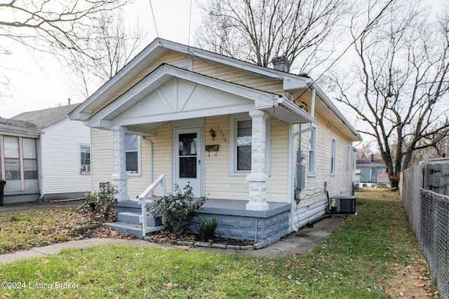 bungalow-style home with cooling unit and covered porch