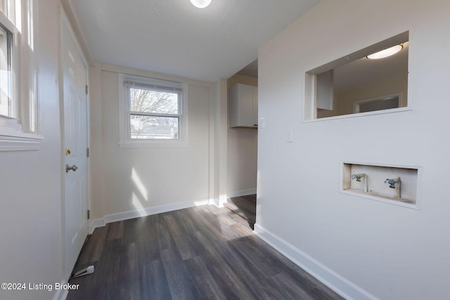 washroom featuring washer hookup, dark hardwood / wood-style flooring, and a textured ceiling