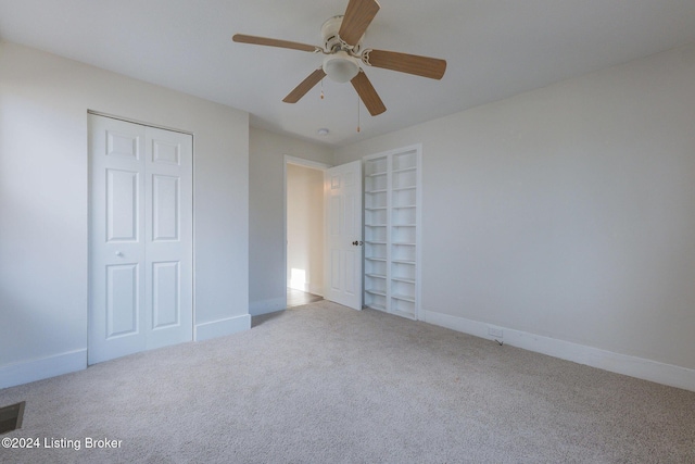 unfurnished bedroom with light carpet, a closet, and ceiling fan