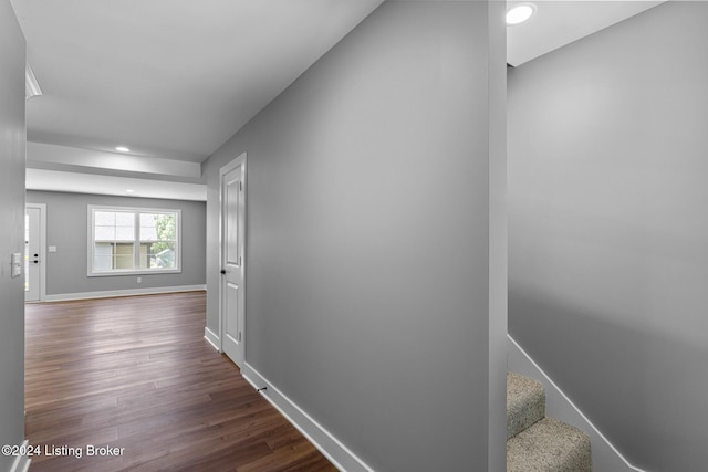 corridor with dark hardwood / wood-style flooring