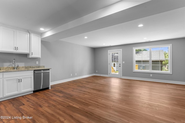 kitchen with light stone countertops, white cabinets, sink, dishwasher, and hardwood / wood-style floors