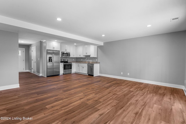 kitchen featuring white cabinets, dark wood-type flooring, and appliances with stainless steel finishes