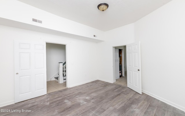 unfurnished bedroom with light wood-type flooring