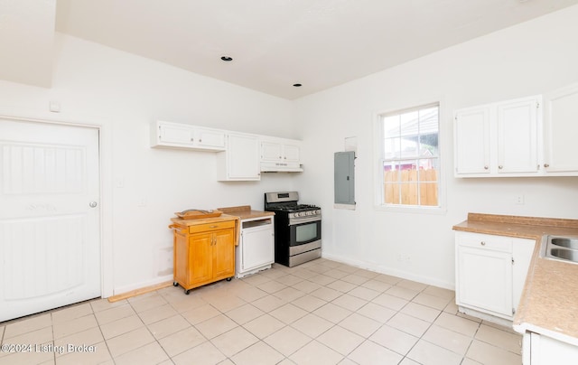 kitchen featuring electric panel, white cabinetry, stainless steel gas stove, and light tile patterned floors