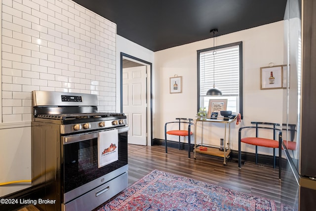 kitchen with decorative backsplash, dark hardwood / wood-style floors, and stainless steel gas range oven