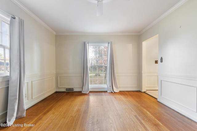 unfurnished room featuring crown molding, light hardwood / wood-style flooring, and ceiling fan