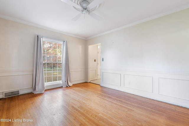 empty room with ceiling fan, light hardwood / wood-style floors, and ornamental molding