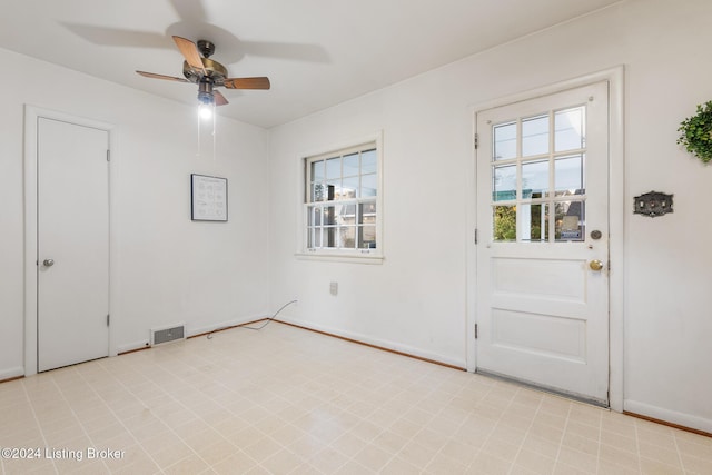 entryway with ceiling fan and a wealth of natural light