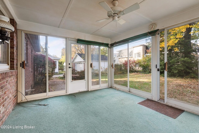 unfurnished sunroom with plenty of natural light and ceiling fan