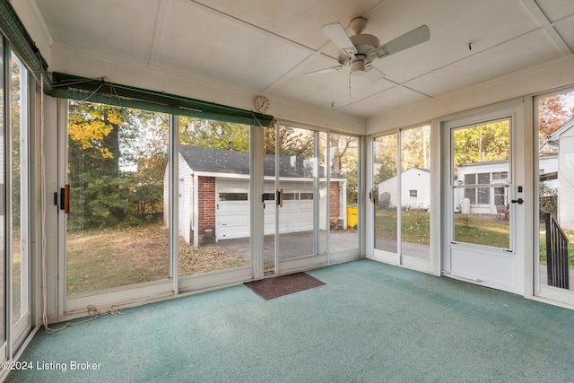 unfurnished sunroom with ceiling fan and a healthy amount of sunlight