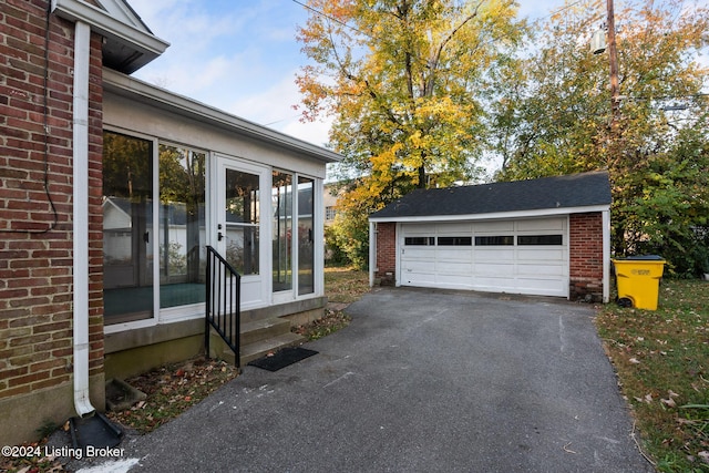 exterior space with a garage and an outdoor structure