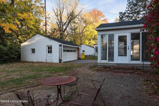 exterior space with an outbuilding and a garage