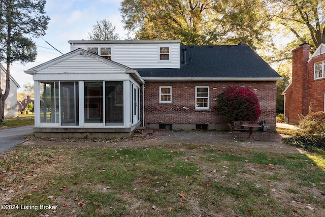 back of house with a sunroom