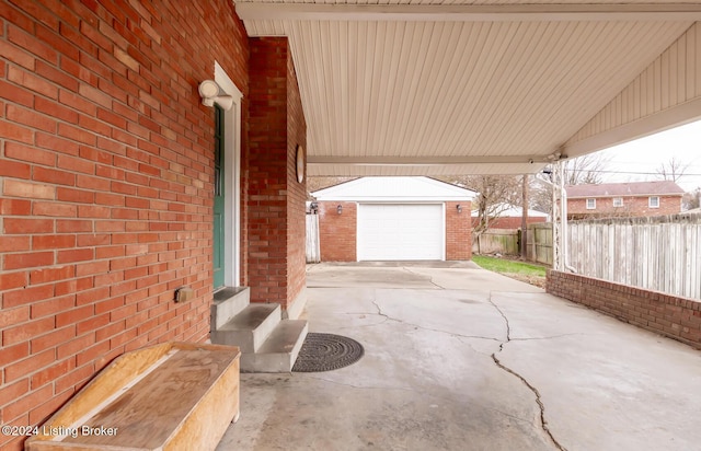 view of patio / terrace featuring an outbuilding and a garage