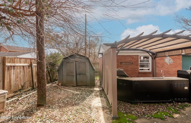 view of yard featuring a pergola and a storage unit