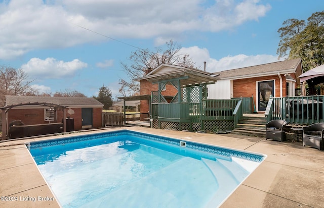 view of swimming pool featuring a wooden deck