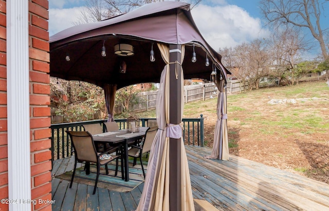 wooden deck with a gazebo and a lawn