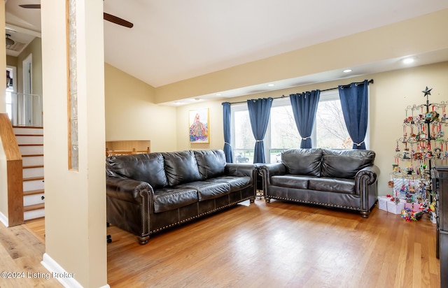 living room with wood-type flooring and vaulted ceiling