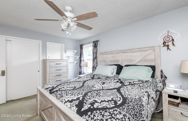 bedroom with light carpet, a textured ceiling, a closet, and ceiling fan