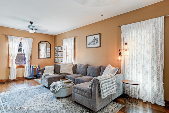 living room featuring ceiling fan and hardwood / wood-style floors