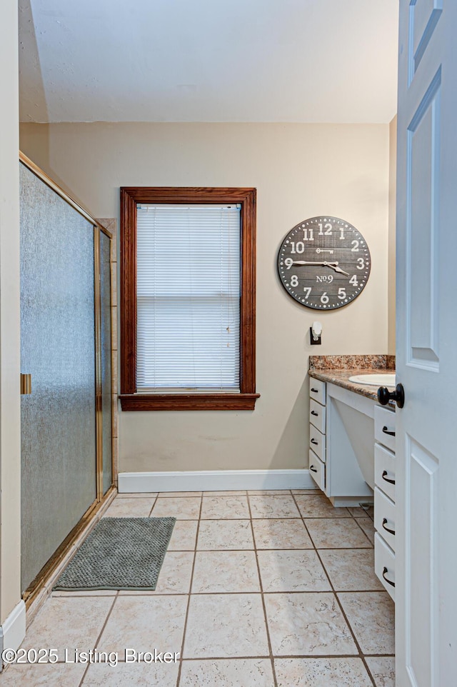 bathroom with tile patterned flooring, vanity, and a shower with shower door